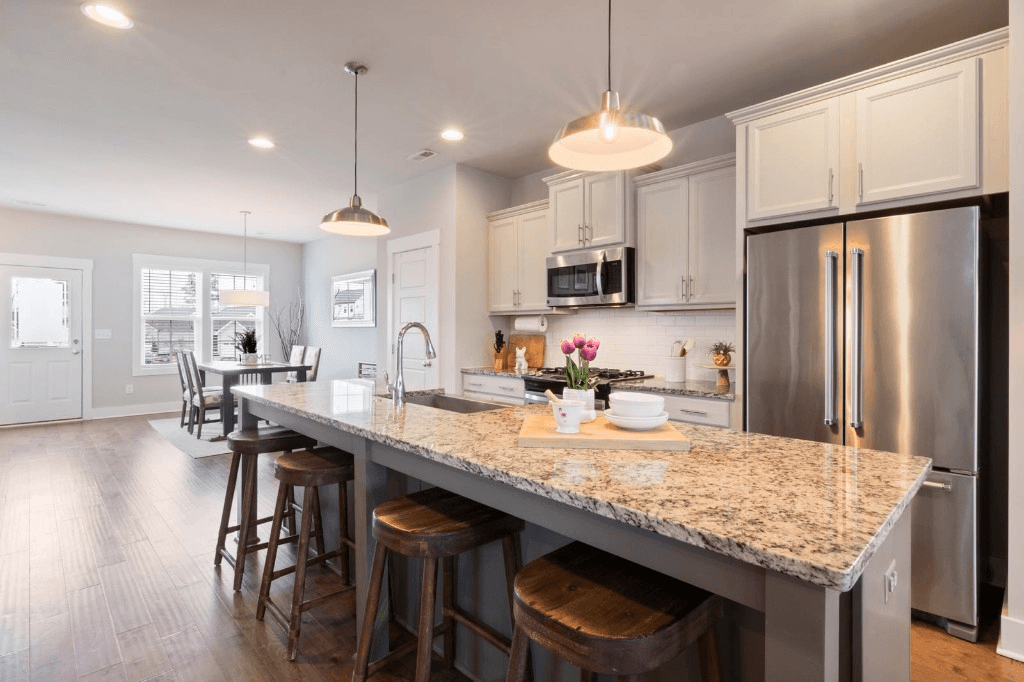 Spotless modern kitchen with granite island and stainless appliances